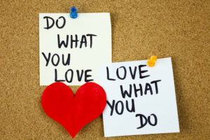 do what you love, love what you do - motivational word advice or reminder on sticky notes on cork board background. Business concept