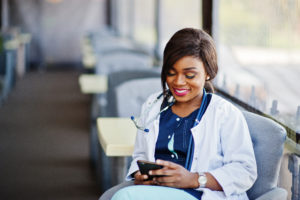 doctor female with stethoscope looked at phone